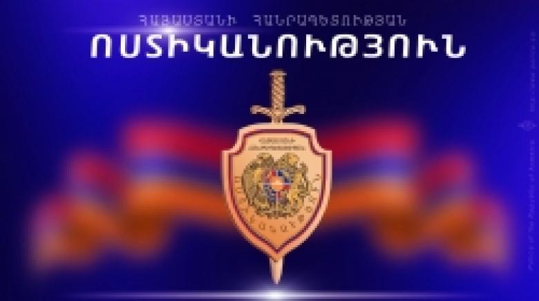 Armenian Police officers detain an ethnic Turk wanted by the U.S. law enforcement agencies
